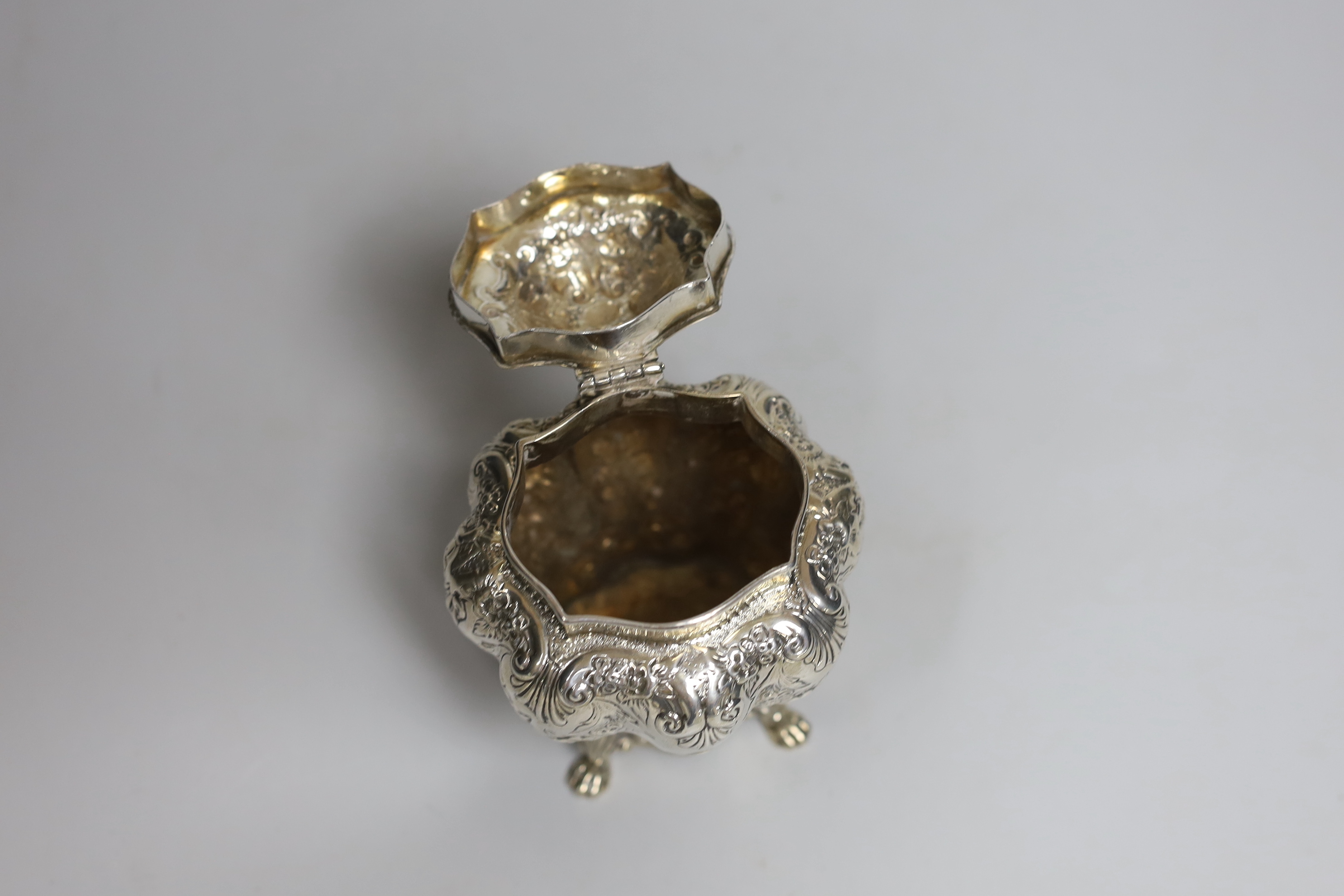 A late Victorian embossed silver bombe shaped tea caddy, Nathan & Hayes, Birmingham, 1894, 14.3cm, 8.4oz.